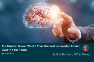 A person in a suit, pointing at a brain indicating leadership mindset